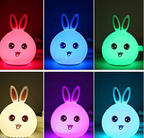 Six colorful rabbit-shaped night lights in different colors on a dark background. Korean Lamps Online Sale Spark and Wrap